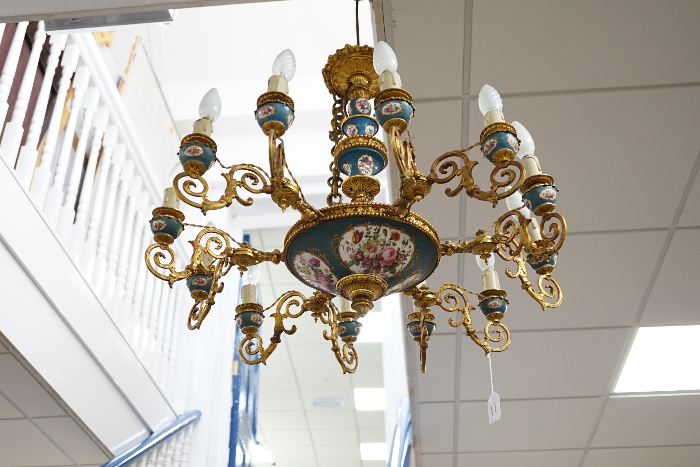 A Sevres style porcelain and gilt metal mounted twelve light chandelier, late 19th / 20th century, 60cm high excluding chain. Condition - fair